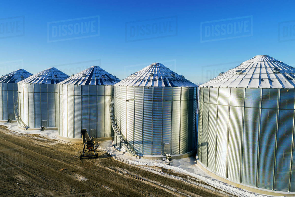 Snow Covered Large Metal Grain Storage Bins With Blue Sky South Of regarding dimensions 1200 X 799
