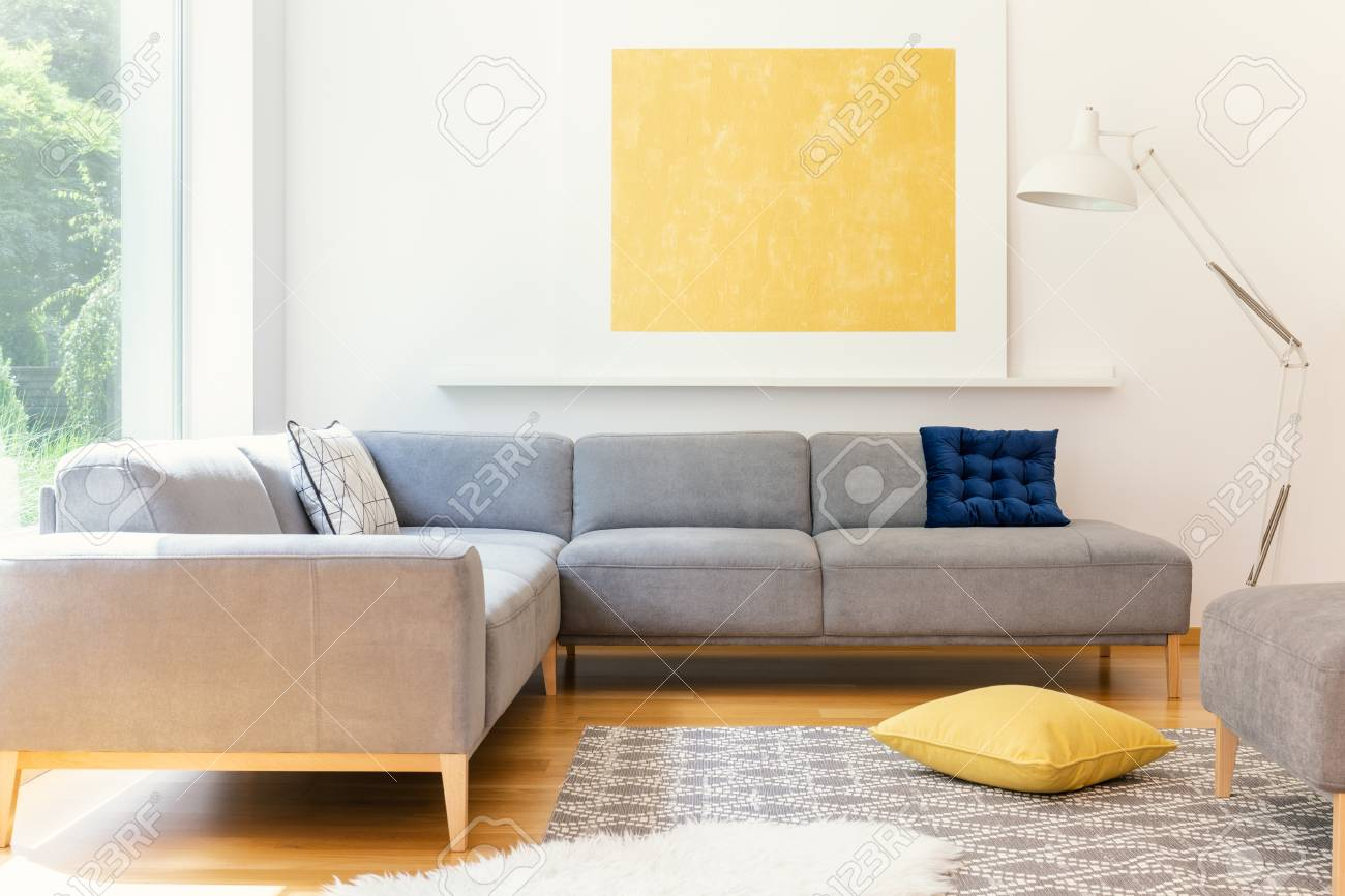 A Minimalist Yellow Poster And A White Industrial Floor Lamp throughout sizing 1300 X 866