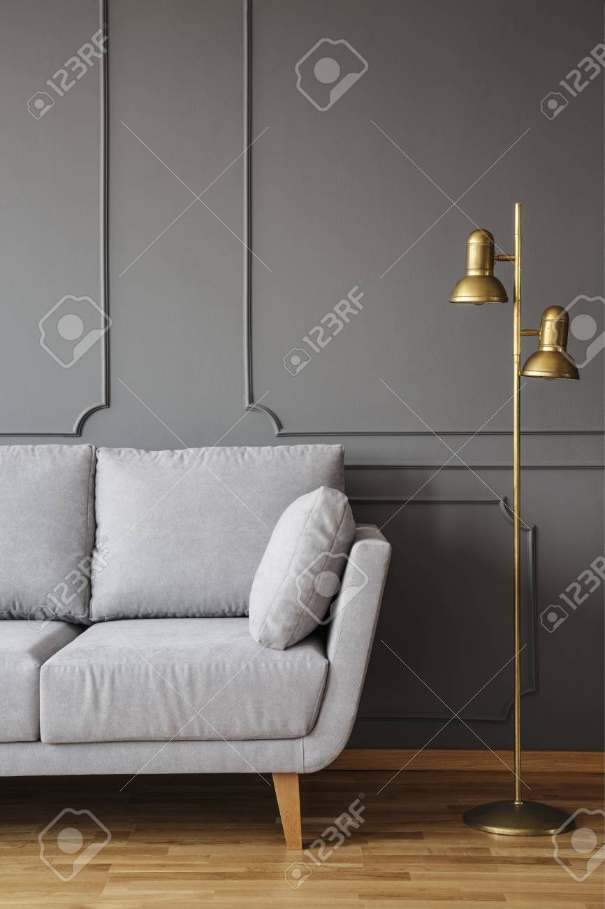 Golden Floor Lamp And A Gray Comfortable Couch In An Elegant in measurements 866 X 1300