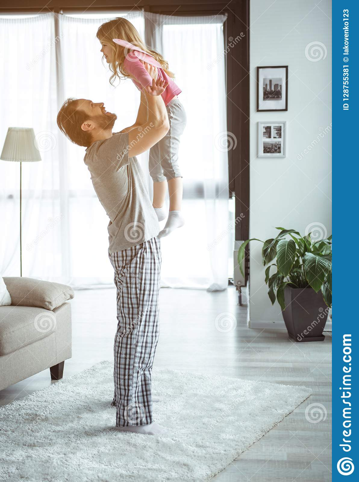 Joyful Father Playing With His Kid At Home Stock Image with size 1192 X 1600