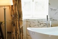 Modern Bathroom Illuminated With Floor Lamp And Marble Wall with regard to proportions 866 X 1390