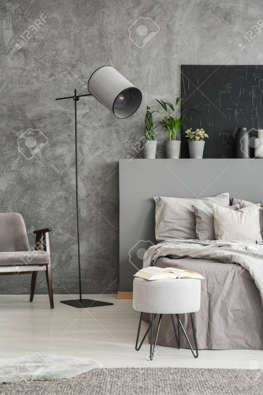 Stylish Standing Lamp Next To A Bed In A Monochromatic Grey Bedroom for dimensions 866 X 1300