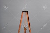 Vintage Wooden Tripod Floor Lamp With White Shade Against Grey regarding size 948 X 1300