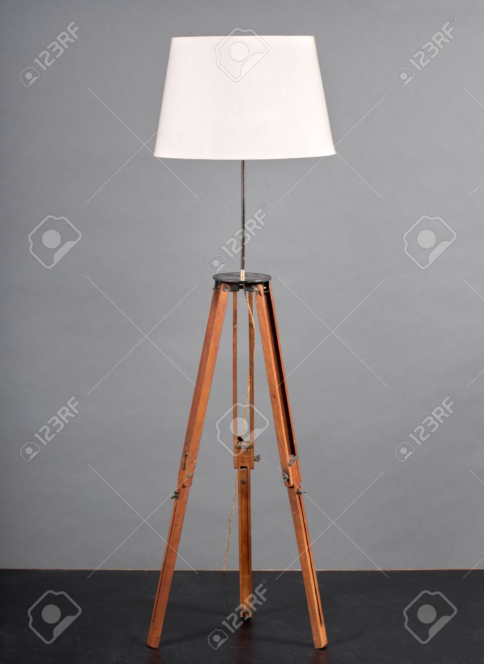 Vintage Wooden Tripod Floor Lamp With White Shade Against Grey regarding size 948 X 1300
